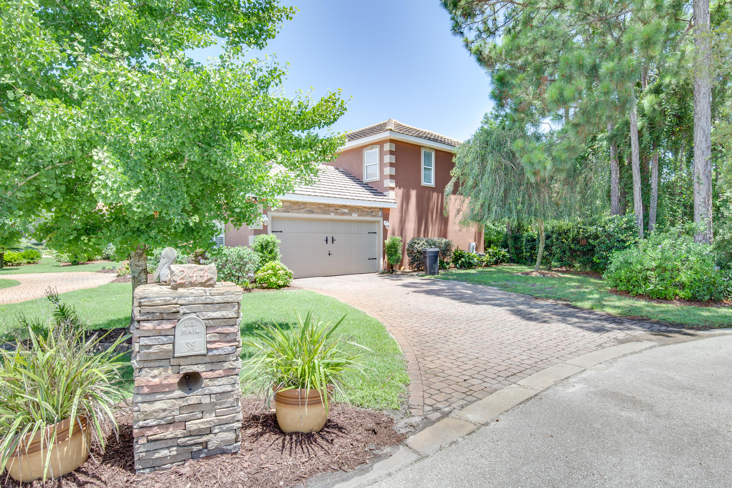 244 Indigo Loop Destin, FL 32550 - Photo 31 of 41 a front view of a house with a yard and fountain