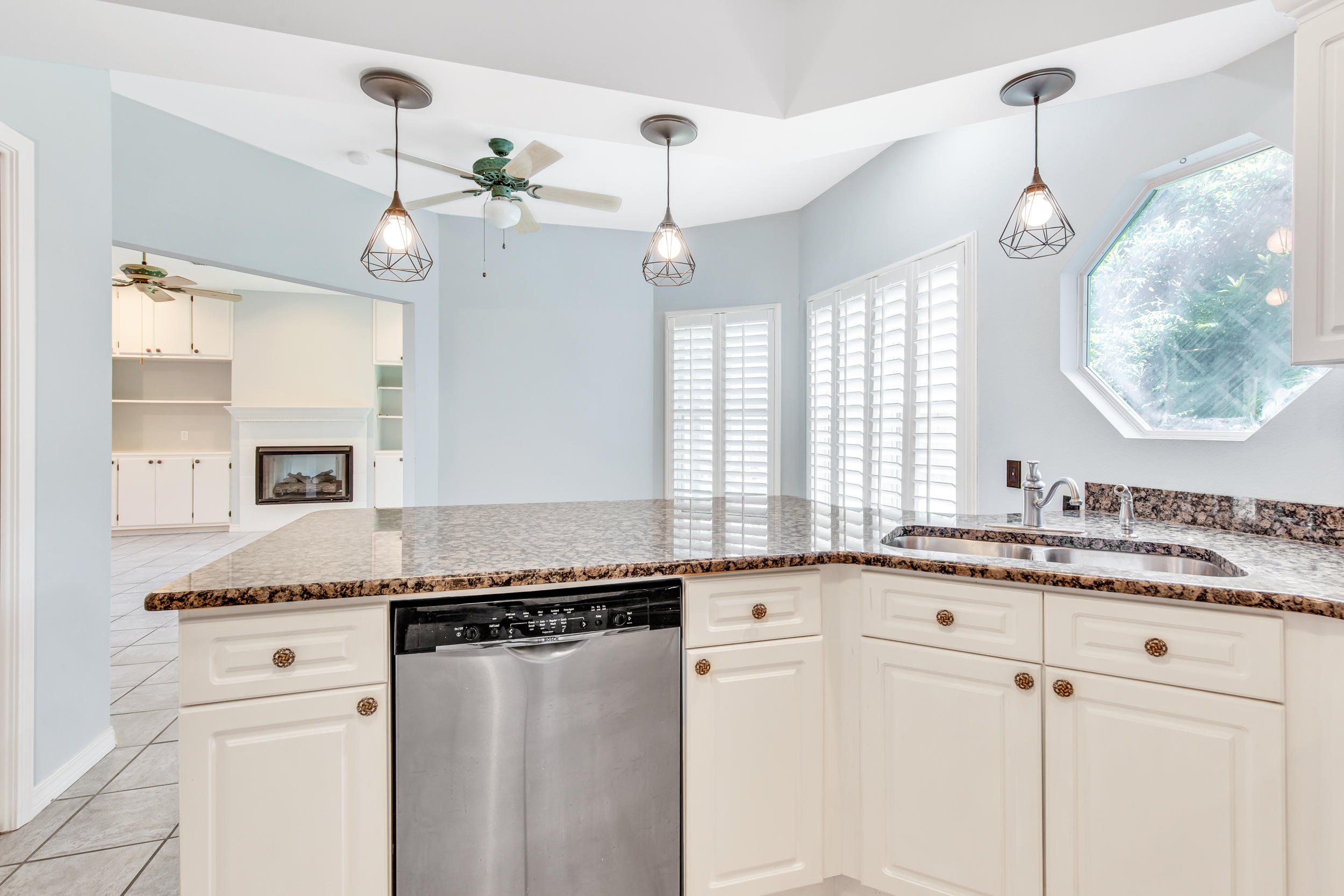 244 Indigo Loop Destin, FL 32550 - Photo 10 of 41 a kitchen with granite countertop cabinets a sink a window and stainless steel appliances