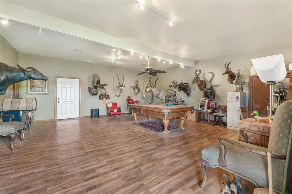 9711 Jim Christal Road Krum, TX 76249 - Photo 30 of 38 a living room with furniture and a wooden floor