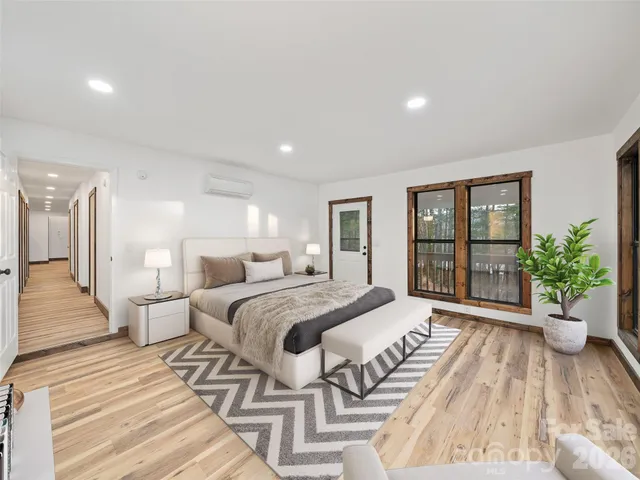 a spacious bedroom with a large bed and a large window