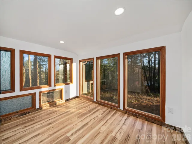 a view of a room with wooden floor and outdoor space