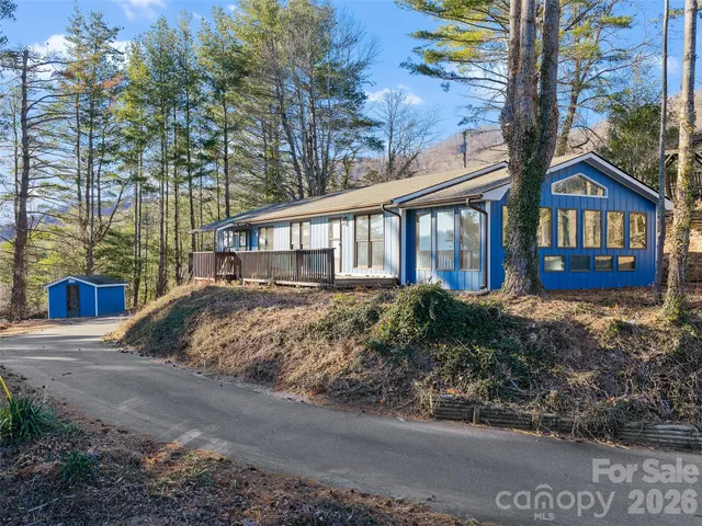 a view of a house with a yard and potted plants