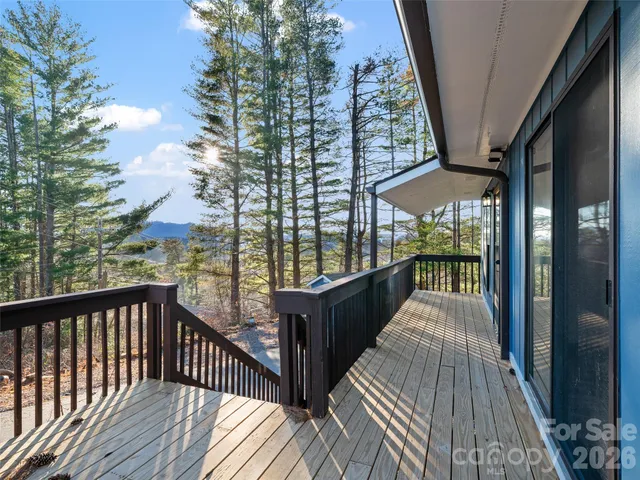 a balcony with wooden floor and outdoor seating