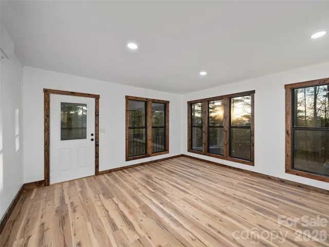 a view of an empty room with glass door and balcony