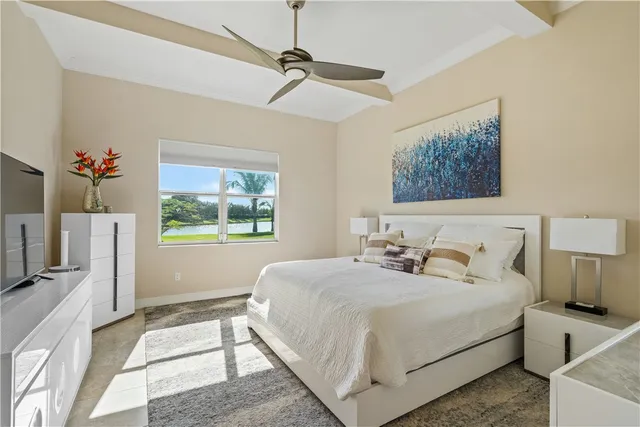 a bedroom with a large bed and a window