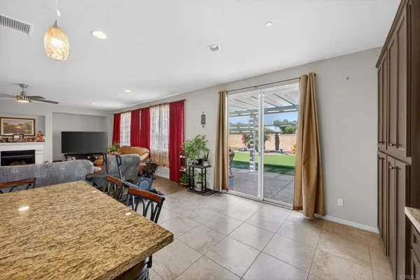 a kitchen with a stove a refrigerator a sink dishwasher and a dining table with garden view