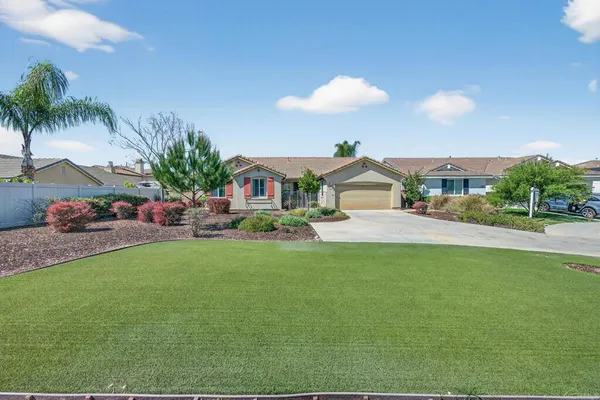 a front view of house with yard and outdoor seating