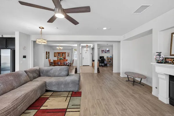 a living room with furniture and a flat screen tv with wooden floor