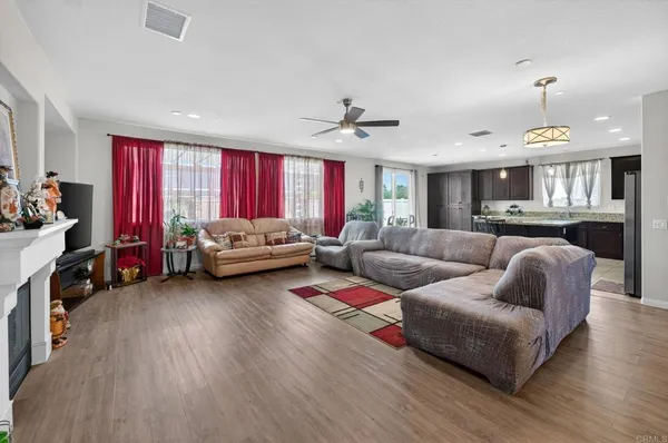 a living room with furniture a fireplace and a flat screen tv