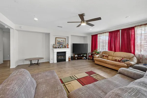 a kitchen with kitchen island granite countertop wooden cabinets a stove a sink and a stainless steel appliances