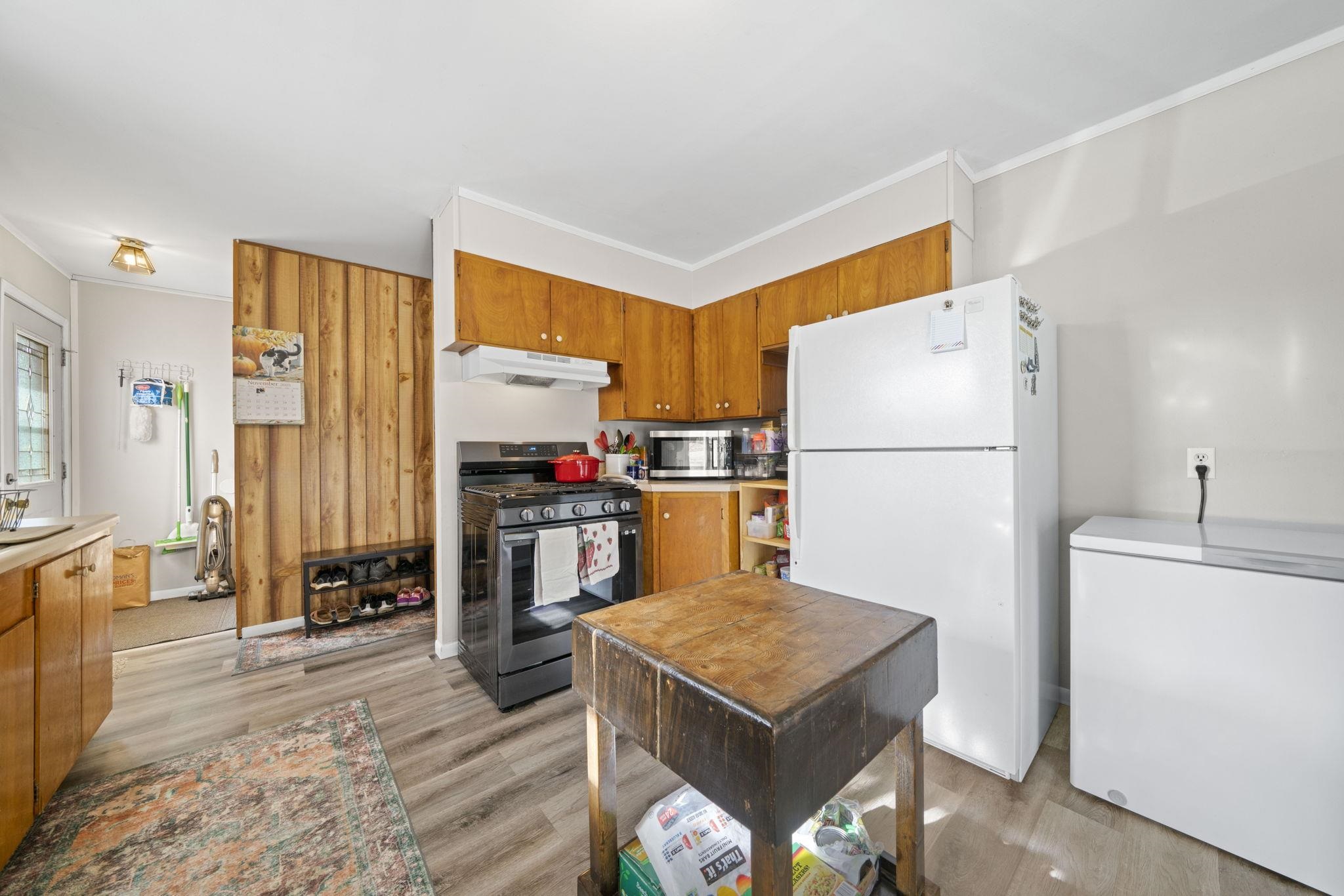 601 West 1st Street Mount Morris, IL 61054 - Photo 14 of 28 a kitchen with a refrigerator a stove a sink dishwasher and a refrigerator with wooden floor