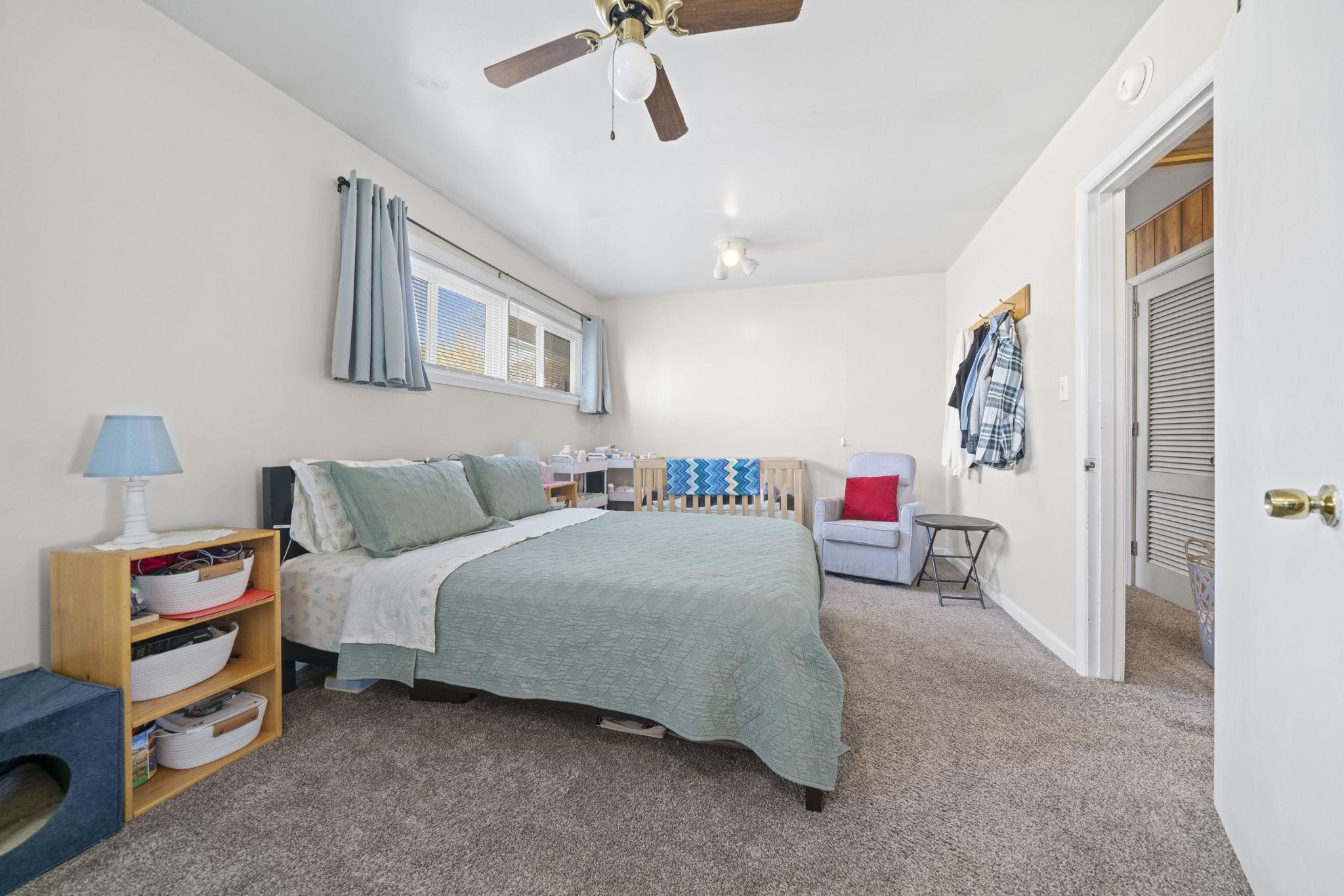 601 West 1st Street Mount Morris, IL 61054 - Photo 18 of 28 a bedroom with bed and a chandelier