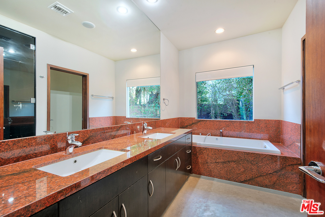 2337 Baxter Street Los Angeles, CA 90039 - Photo 11 of 16 a bathroom with a granite countertop sink and a large mirror