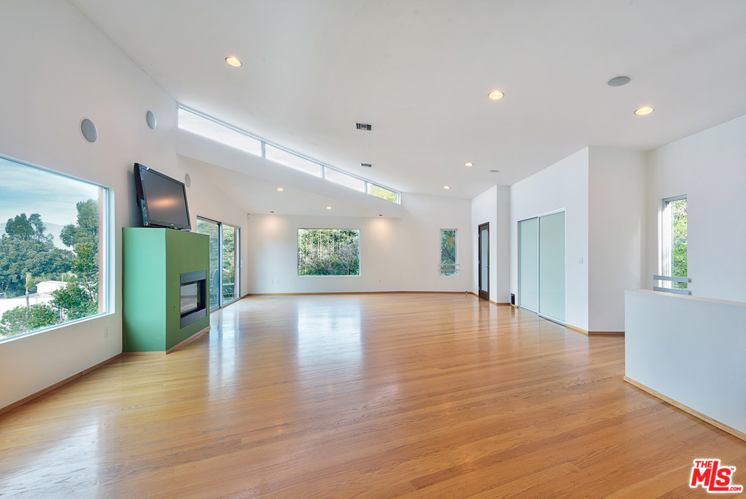 2337 Baxter Street Los Angeles, CA 90039 - Photo 4 of 16 a view of an empty room with wooden floor and a window