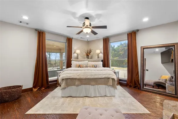 a bedroom with a large bed and a large window
