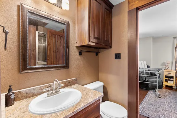 a bathroom with a toilet sink and mirror