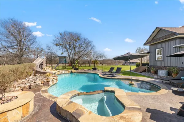 a view of a swimming pool with a patio