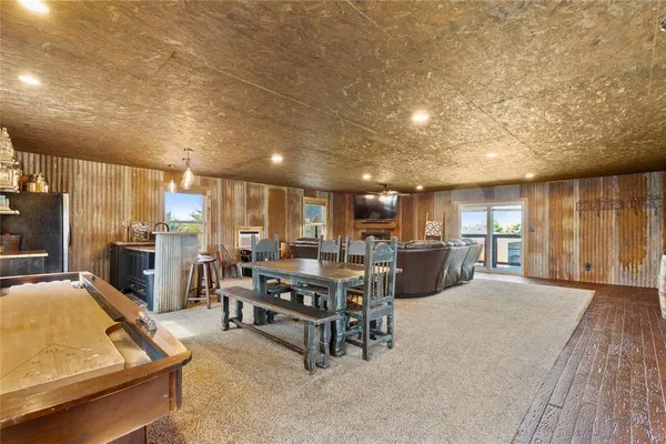 a living room with lots of furniture and kitchen view