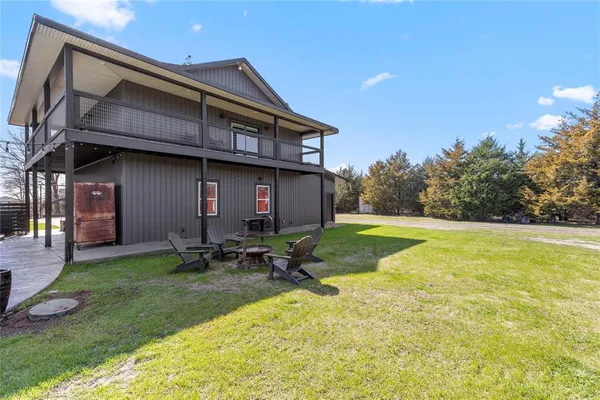 a backyard of a house with table and chairs