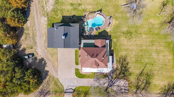 an aerial view of residential house with outdoor space and swimming pool