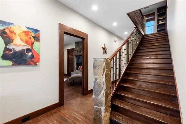 a view of entryway and hall with wooden floor