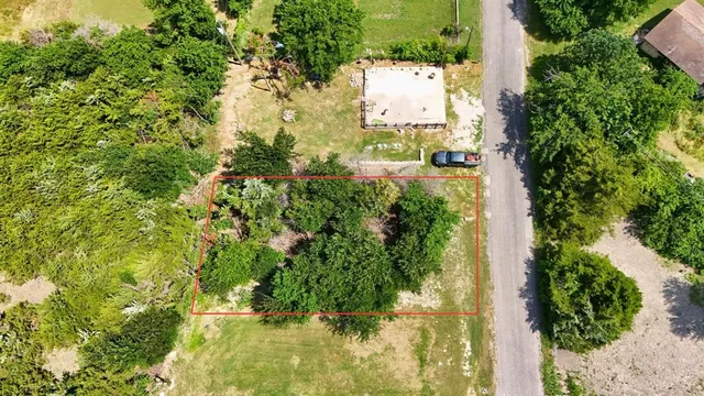 an aerial view of residential house with green space