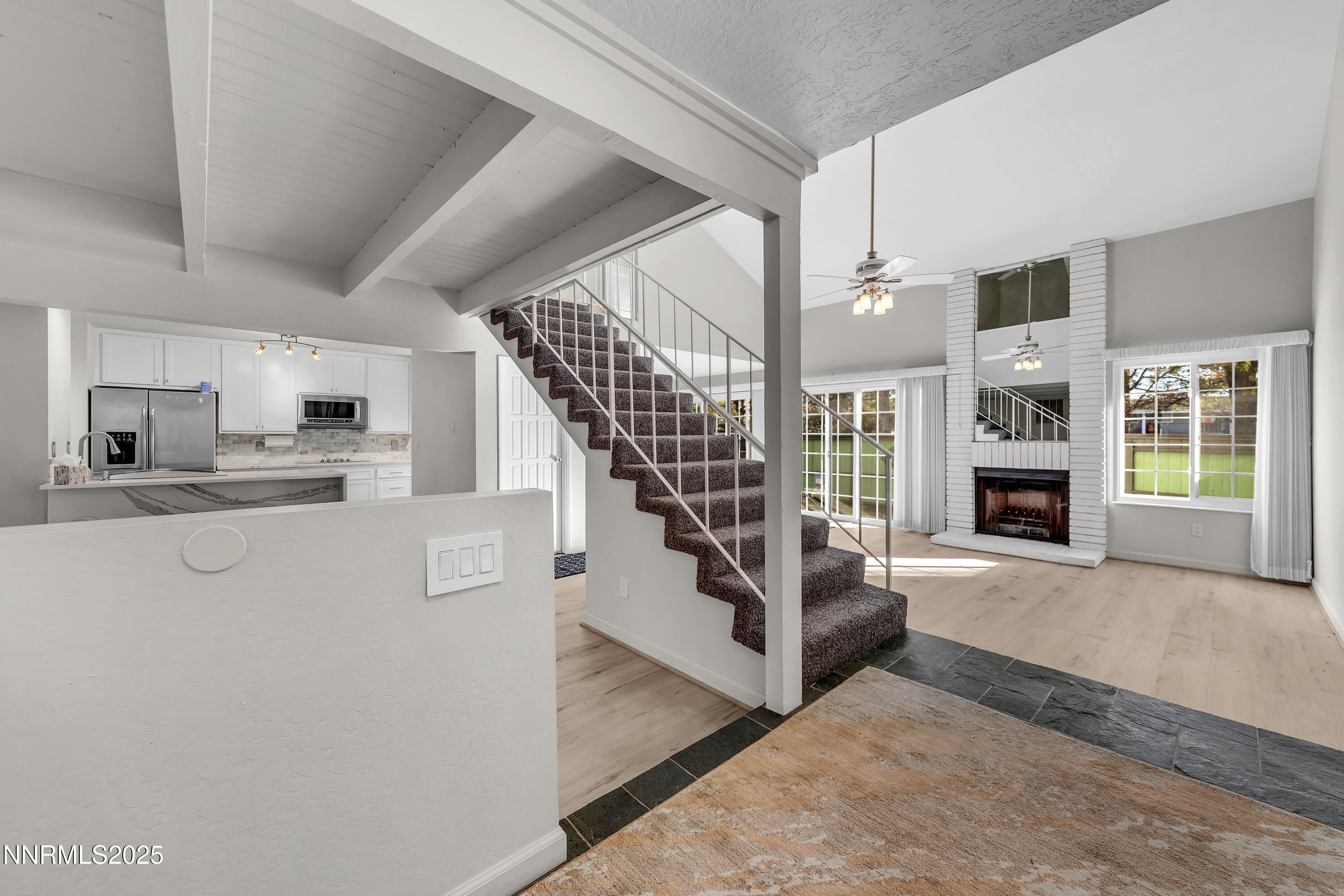 a view of a living room with furniture and a fireplace