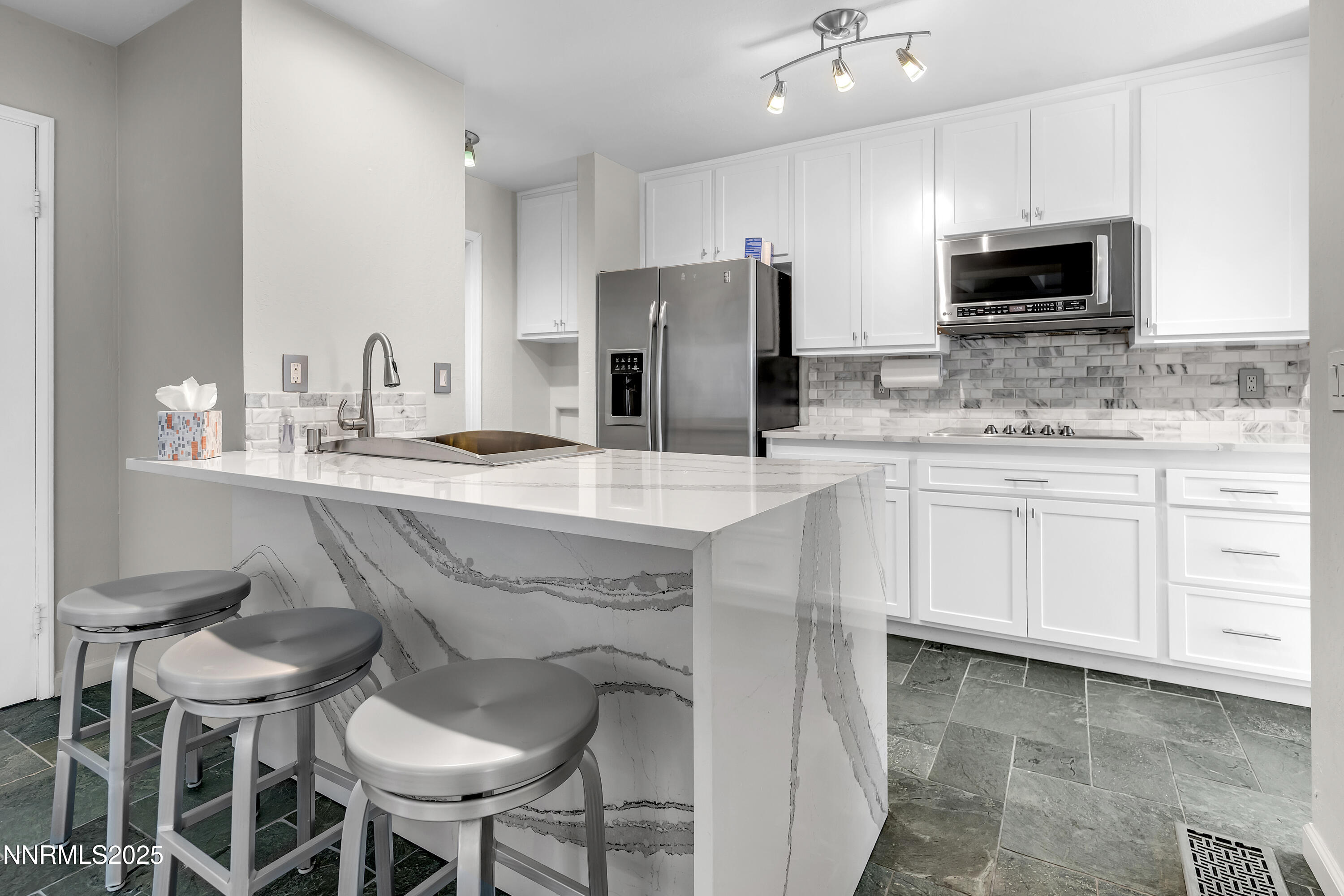 4314 Clyde Court Reno, NV 89509 - Photo 11 of 46 a kitchen with stainless steel appliances a sink and chairs