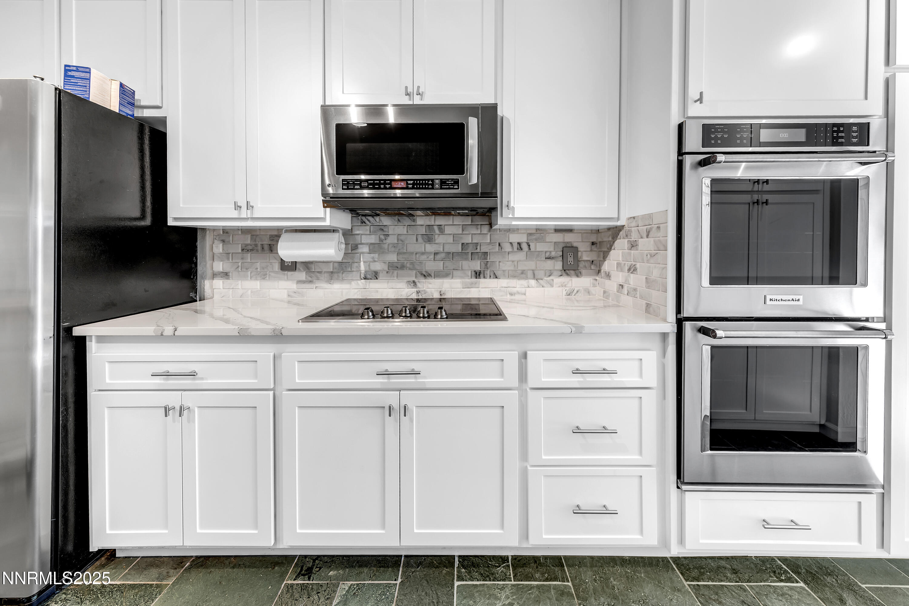 4314 Clyde Court Reno, NV 89509 - Photo 12 of 46 a kitchen with white cabinets and stainless steel appliances