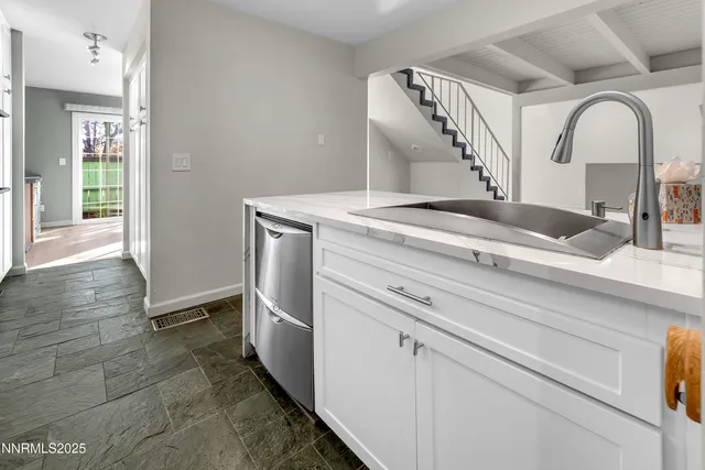 a kitchen with stainless steel appliances a sink and a refrigerator