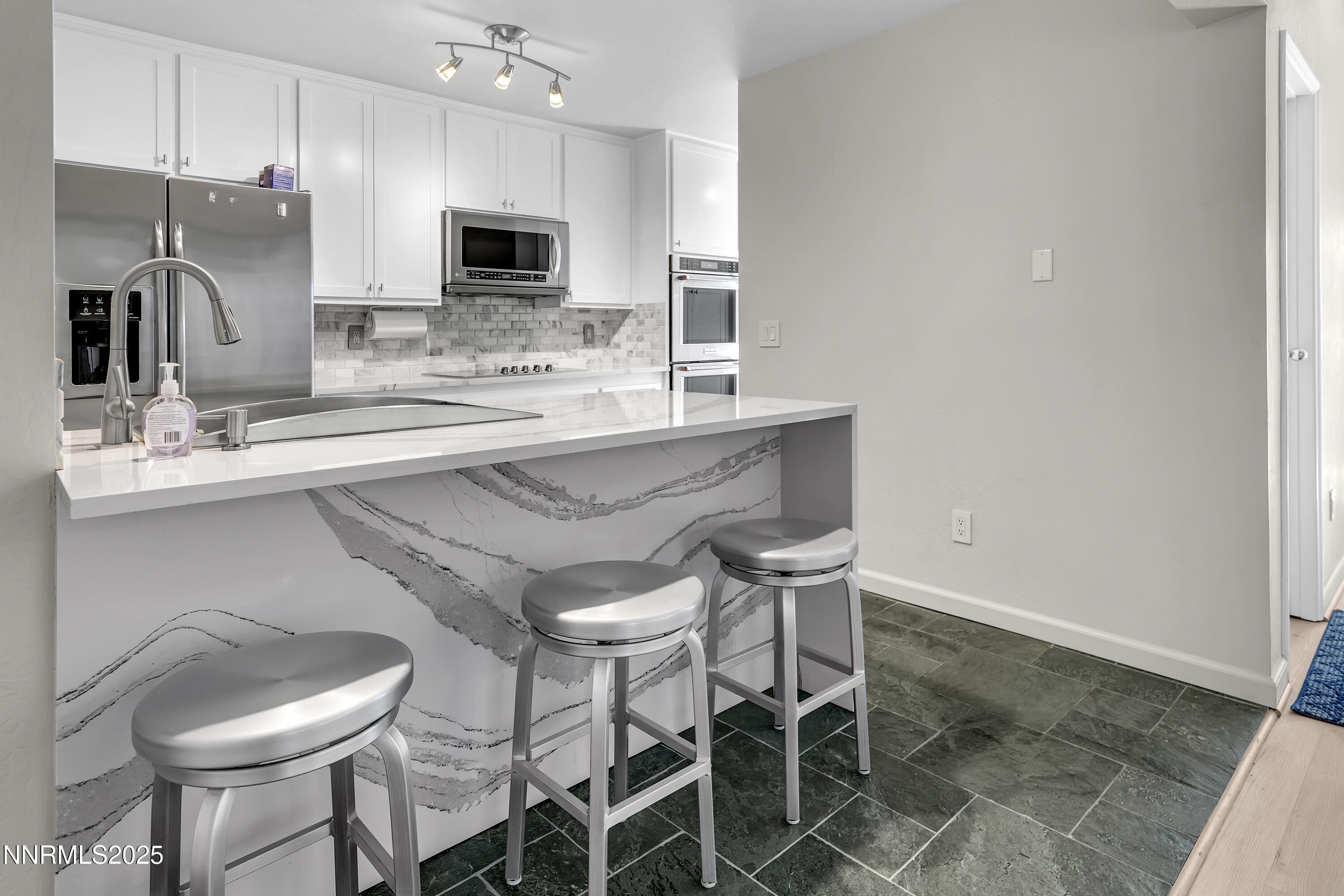 4314 Clyde Court Reno, NV 89509 - Photo 14 of 46 a kitchen with stainless steel appliances a sink and a refrigerator
