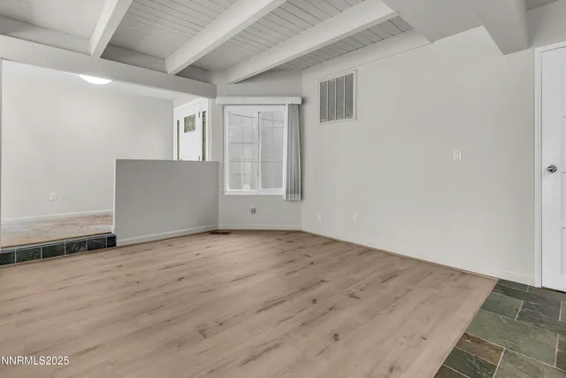 a large white kitchen with a large window