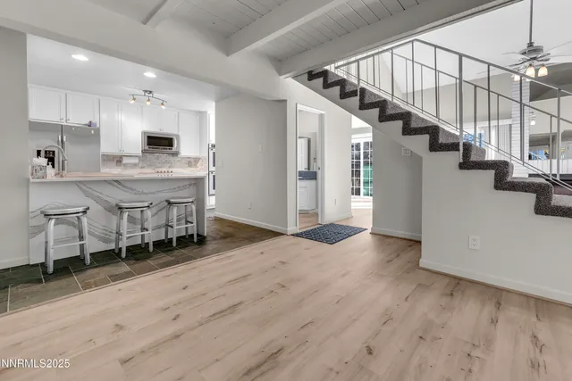 a bathroom with a granite countertop toilet and a sink