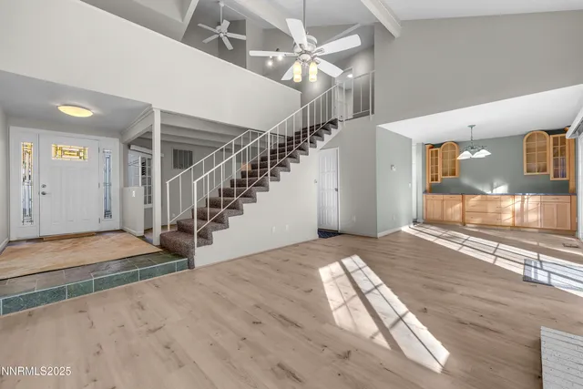 a view of entryway and hall with wooden floor