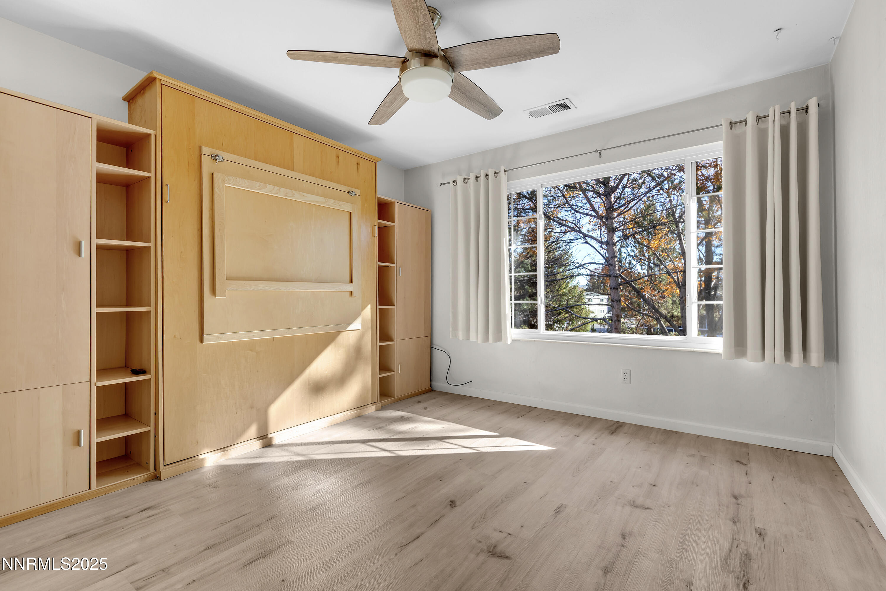 4314 Clyde Court Reno, NV 89509 - Photo 28 of 46 a view of an empty room with a window and wooden floor