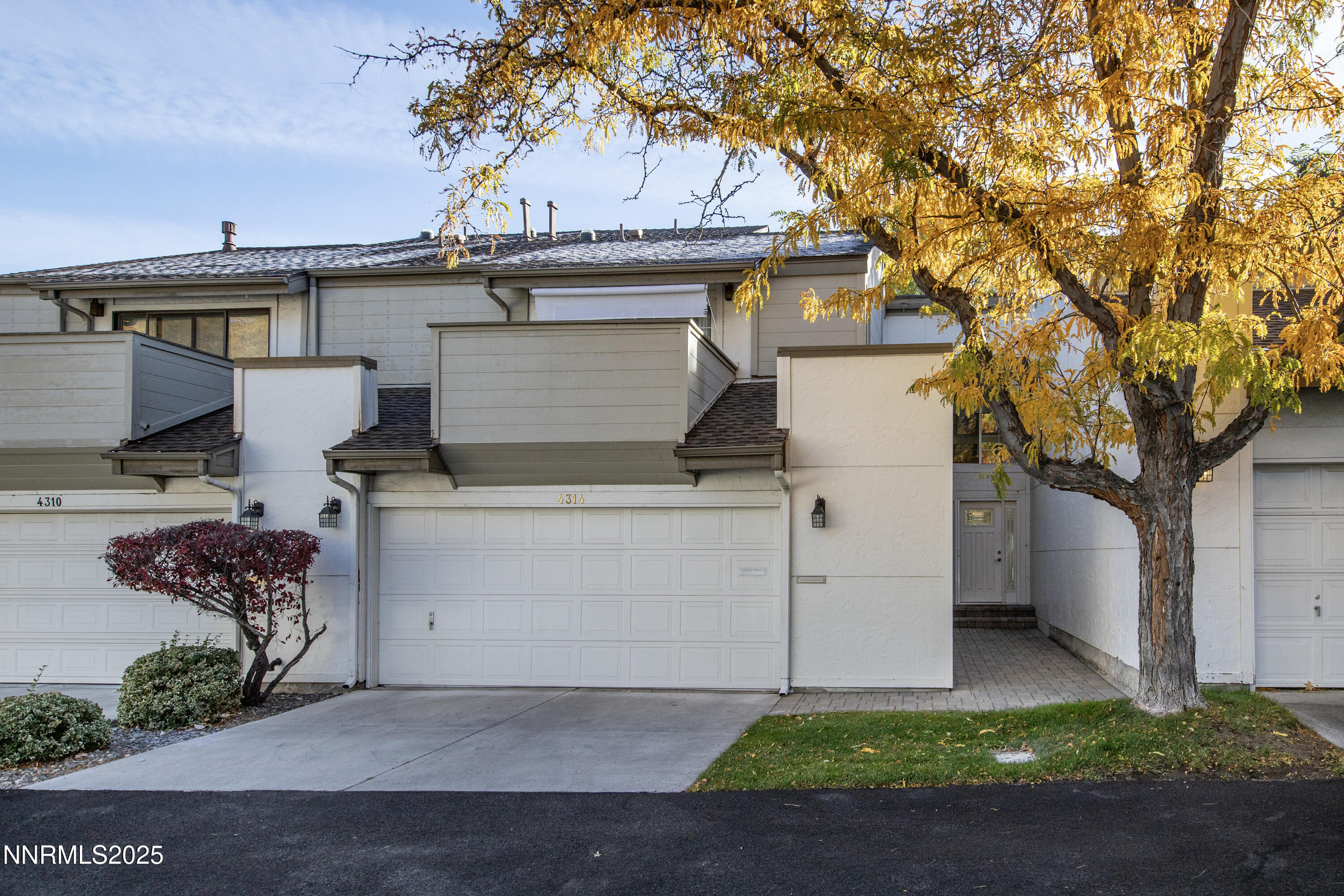 4314 Clyde Court Reno, NV 89509 - Photo 45 of 46 a view of a white house with a large tree and a yard