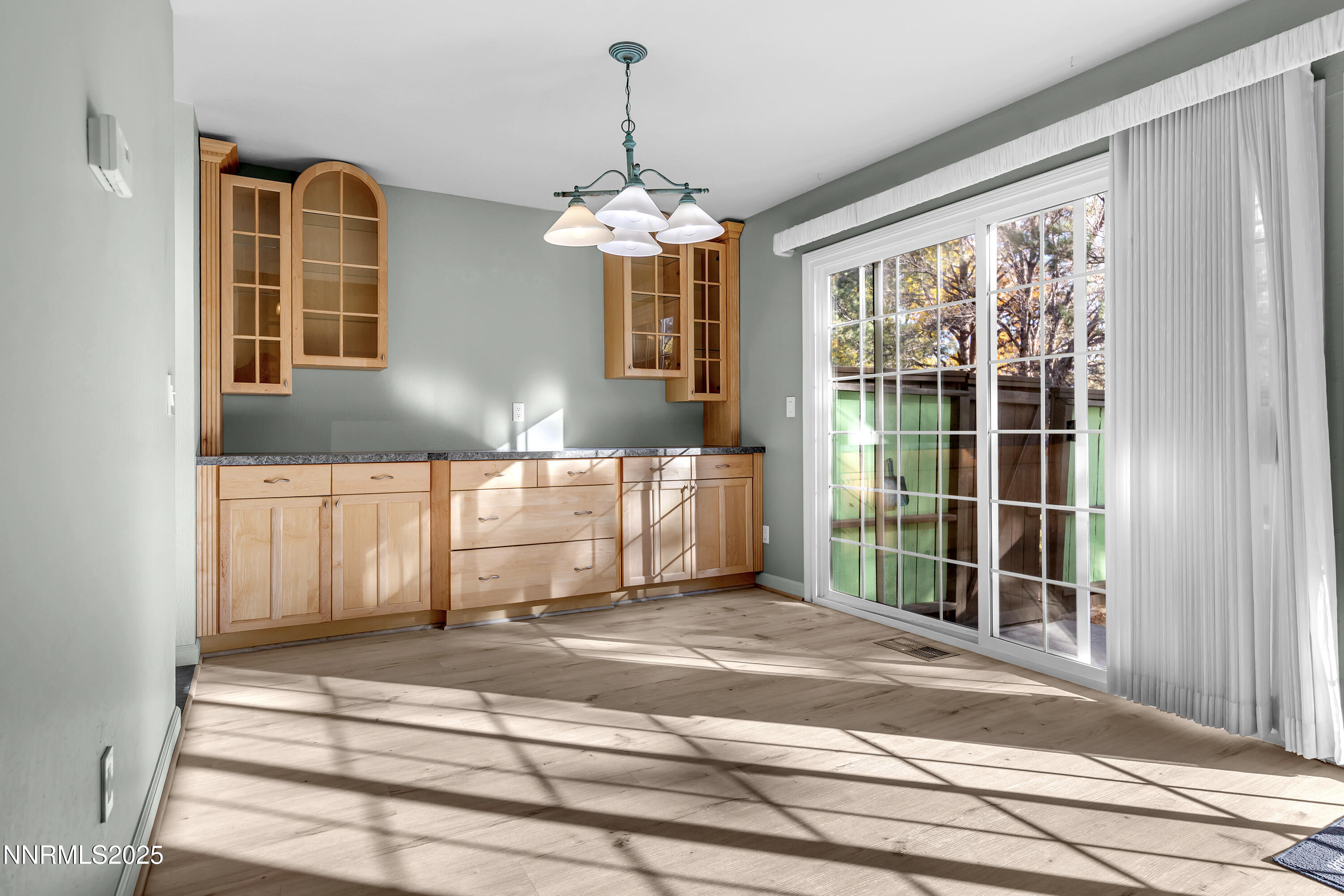 4314 Clyde Court Reno, NV 89509 - Photo 7 of 46 a bedroom with a bed and a chandelier