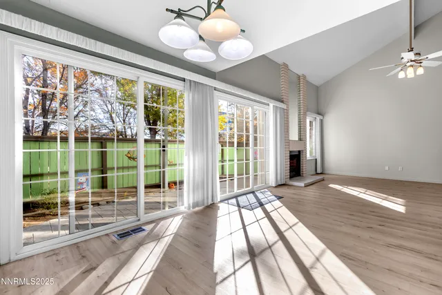 a view of a room with wooden floor and windows