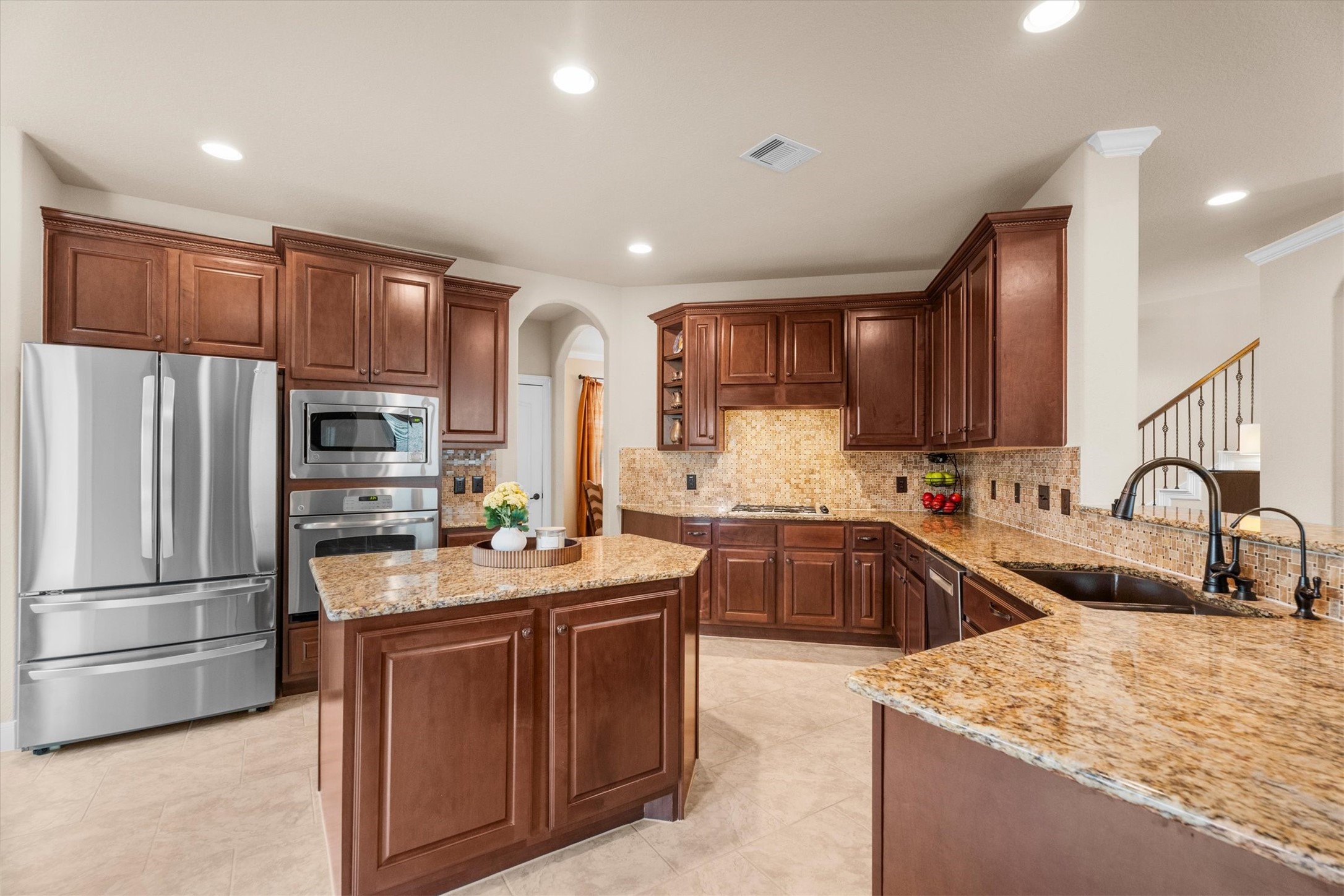 3 Indigo Bunting Place Spring, TX 77389 - Photo 4 of 41 Elegant dark wood cabinetry, granite countertops, and a large center island make this kitchen an entertainer's dream.