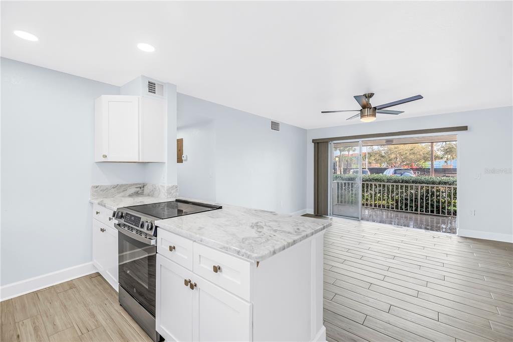 8630 Blind Pass Road St. Pete Beach, FL 33706 - Photo 17 of 26 a kitchen with a stove a sink and a refrigerator