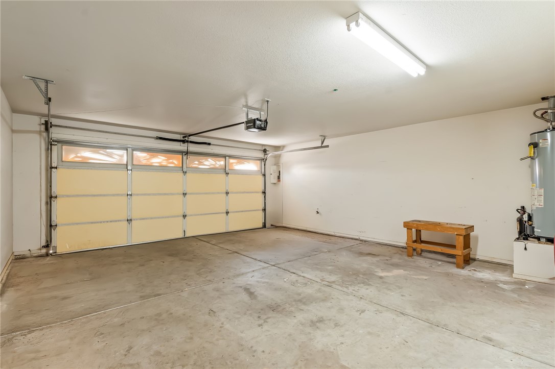 2853 Winchester Road Bullhead City, AZ 86442 - Photo 28 of 40 Spacious garage featuring a concrete floor, a garage door with windows, and a ceiling-mounted light fixture