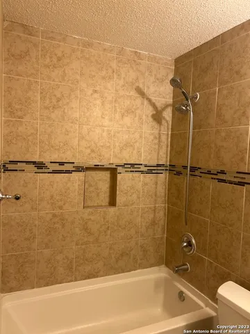 a bathroom with a shower and a bathtub