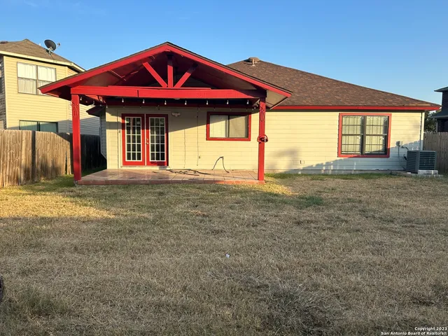 a view of a house with a porch and a yard