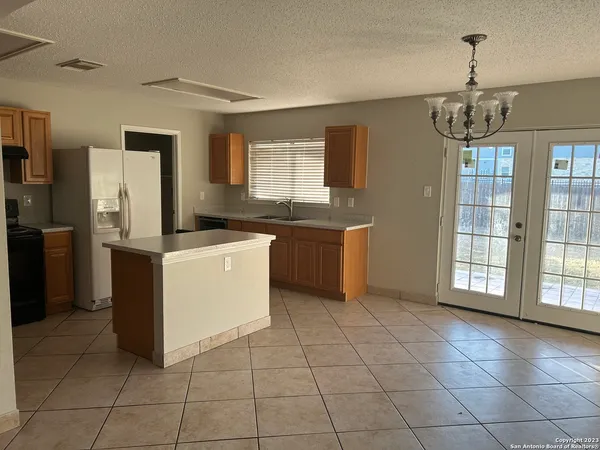 a kitchen that has a sink stainless steel appliances a counter space and a window