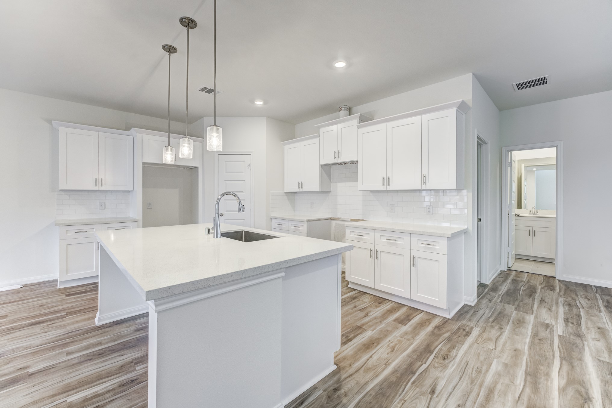 20646 Dynamic Court Humble, TX 77338 - Photo 12 of 40 a kitchen with a sink a stove a refrigerator and white cabinets