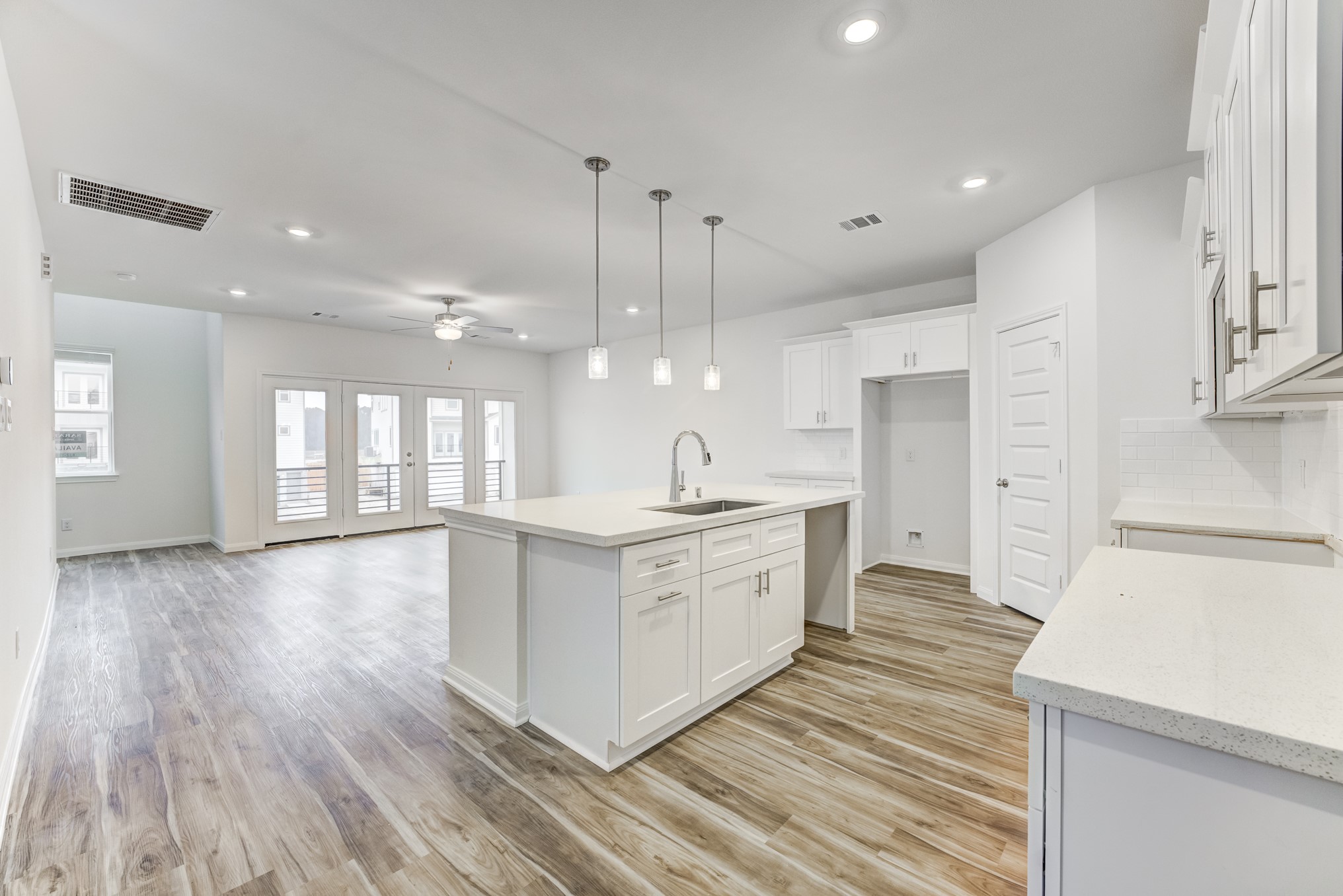 20646 Dynamic Court Humble, TX 77338 - Photo 6 of 40 a large kitchen with stainless steel appliances a large counter top a sink a refrigerator and white cabinets