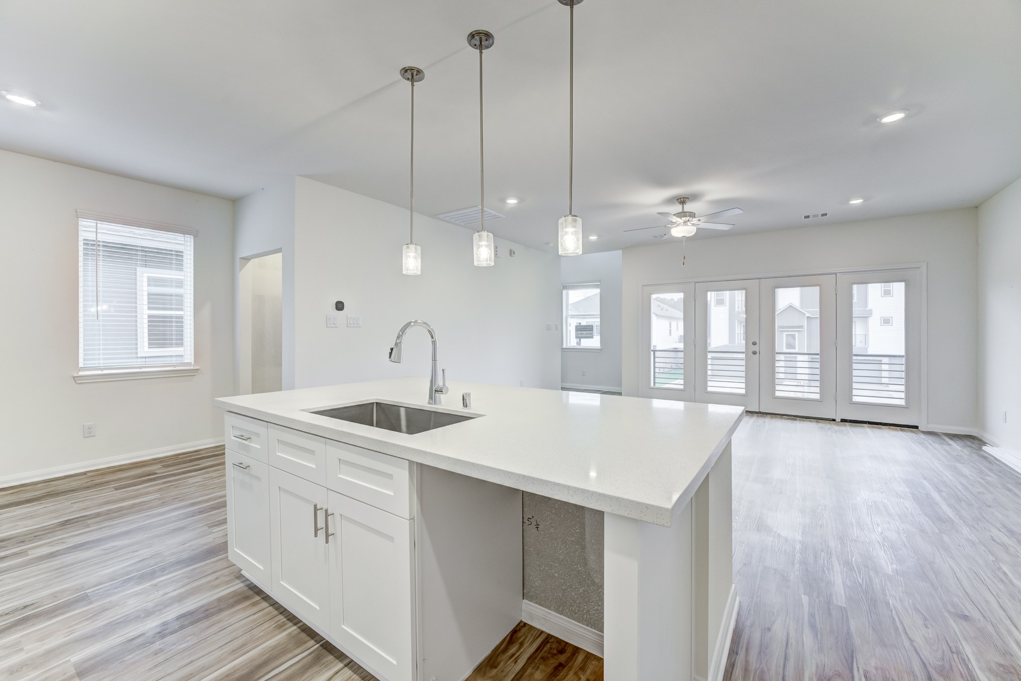 20646 Dynamic Court Humble, TX 77338 - Photo 9 of 40 a large kitchen with kitchen island a large island in center island a sink and a large window
