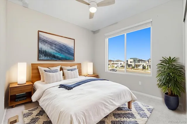 a bedroom with a bed and a potted plant