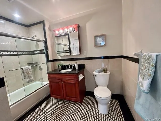 a bathroom with a sink a toilet and a shower