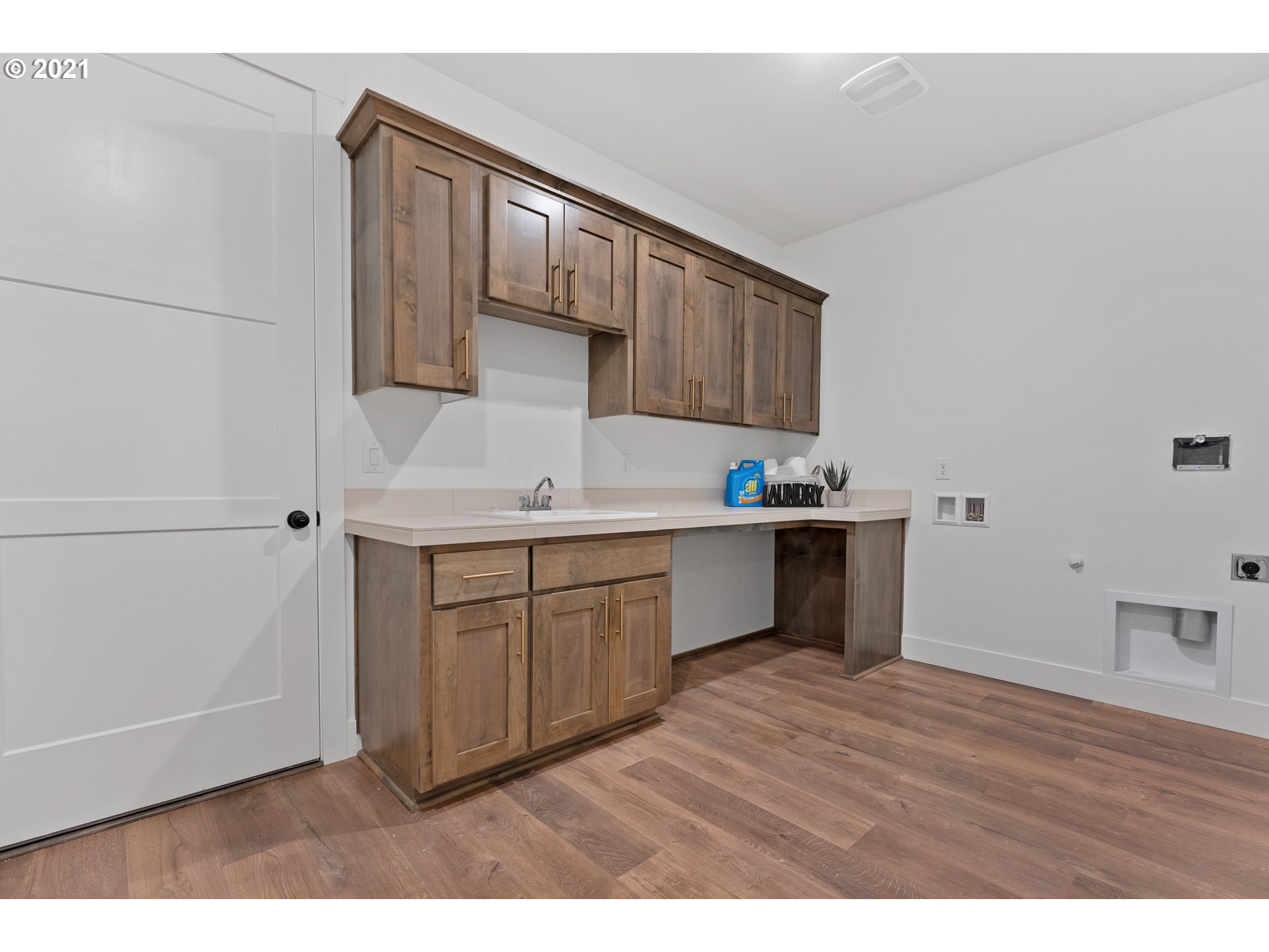 912 South 88th Avenue Ridgefield, WA 98642 - Photo 18 of 32 a kitchen with a sink cabinets and wooden floor